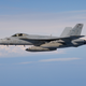 An F/A-18E from VFA-147 carrying three external fuel tanks for the carrier refueling mission.